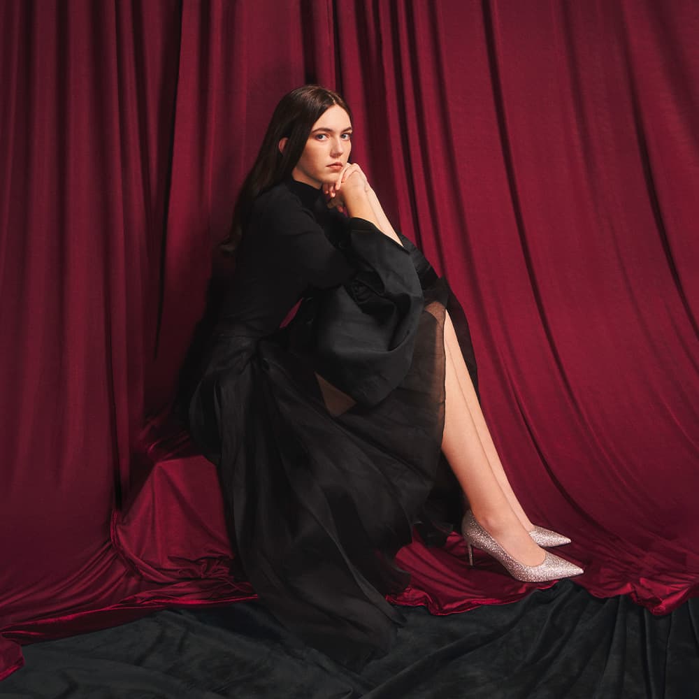 Women's textured hammered buckle bag in sage green and women's lace-up combat boots in olive - CHARLES & KEITH