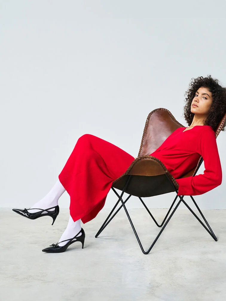 Black heels paired with a long-sleeved red dress.