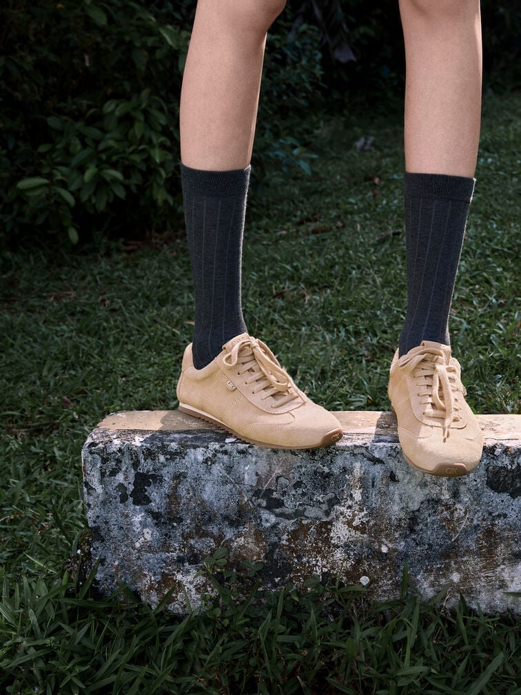 Wear suede low-profile trainers with black calf socks to create a preppy-cool aesthetic. 