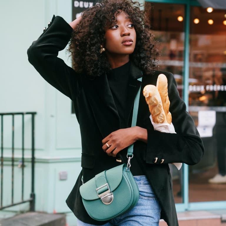 Women’s Amelia metallic push-lock crossbody bag and Elery slip-on ankle boots, as seen on Emmanuelle Koffi - CHARLES & KEITH