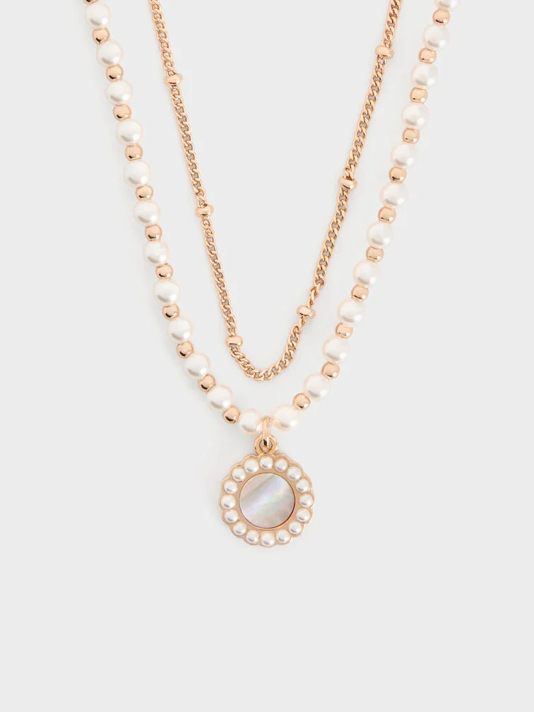 A pearl-embellished double-chain necklace offers a ready-made layered look that is bold and chic.