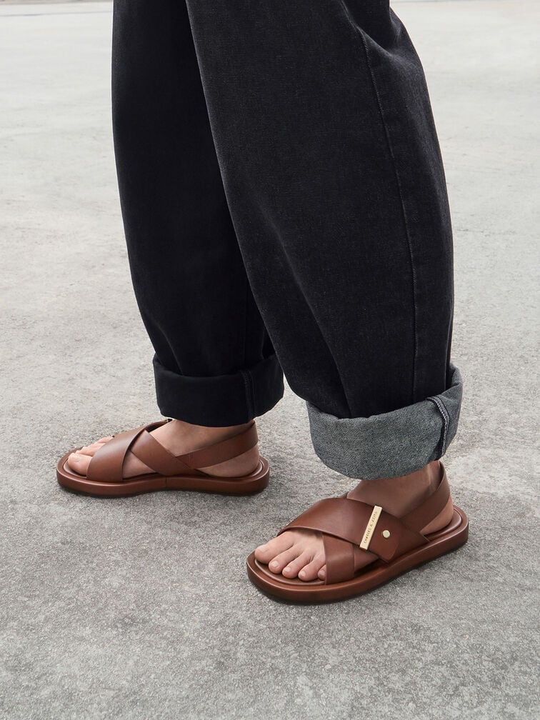 Brown shoes complement dark-wash denim. 