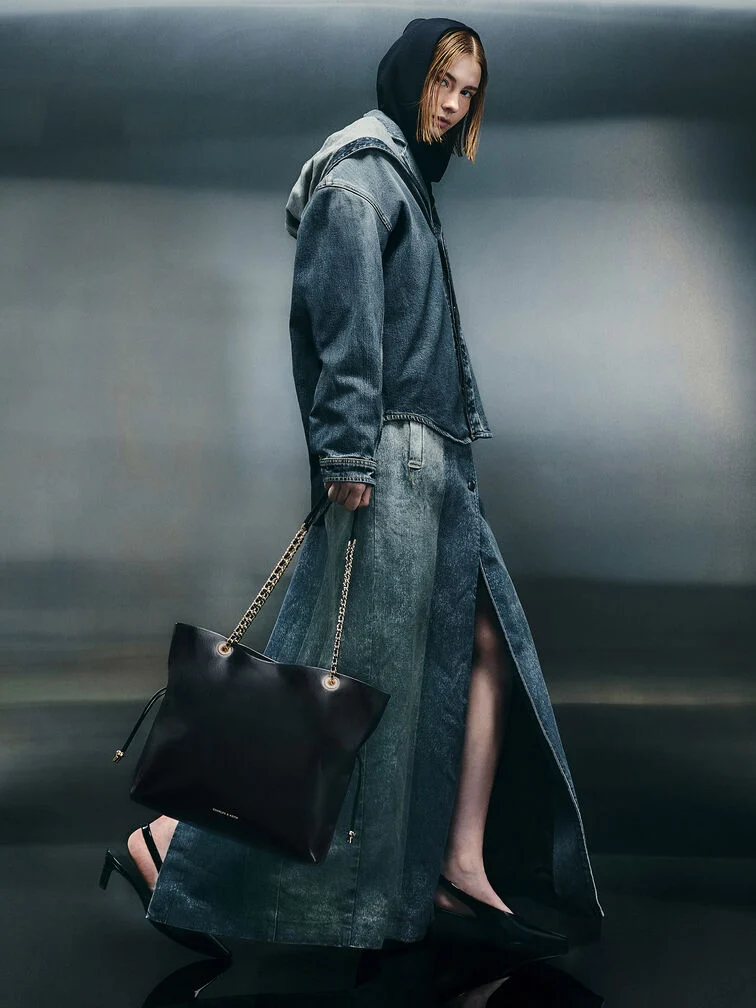 Pair a hooded denim jacket with a high-split denim maxi skirt and complete this cool streetstyle look with an edgy chain-handle black tote 
