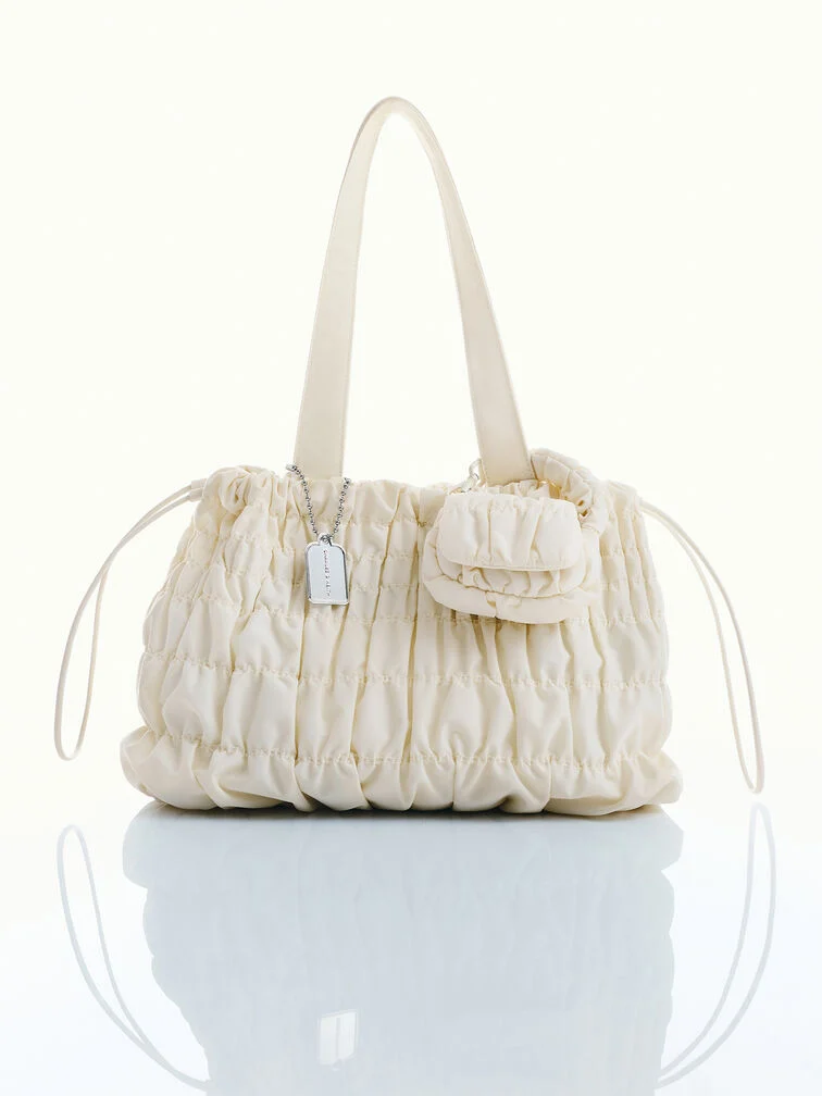 The Klio micro bag charm paired with the Klio bag.