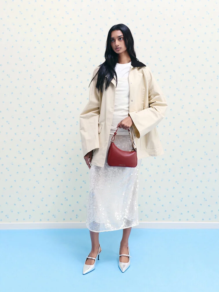 A head-to-toe winter white outfit accessorised with a burgundy bag for a pop of colour.