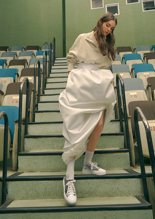 A model in a pair of shiny metallic platform sneakers.