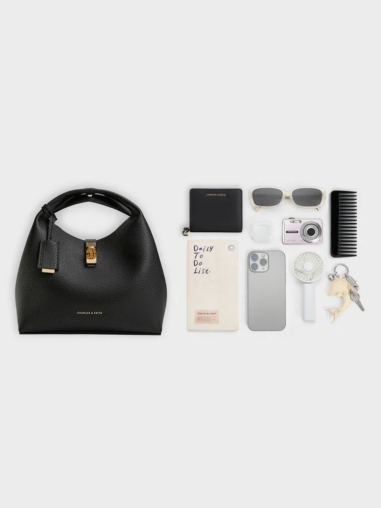 Black bucket bag, compact and ideal for carrying only essentials on slower workdays.