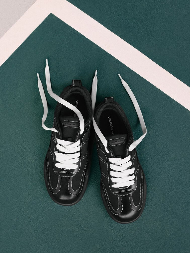 Trendy, black low-profile trainers will effortlessly complement your denim-on-denim outfit.  