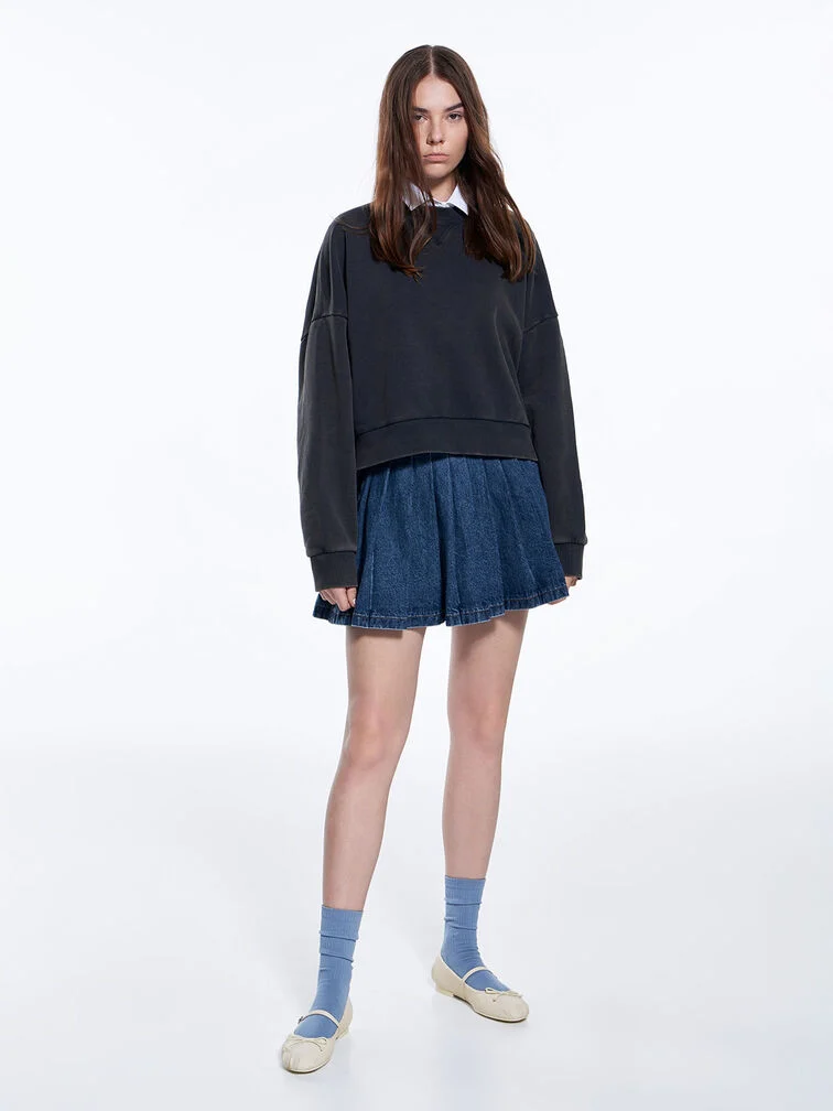 Chalk Mary Janes styled with socks, a sweater and a pleated skirt.