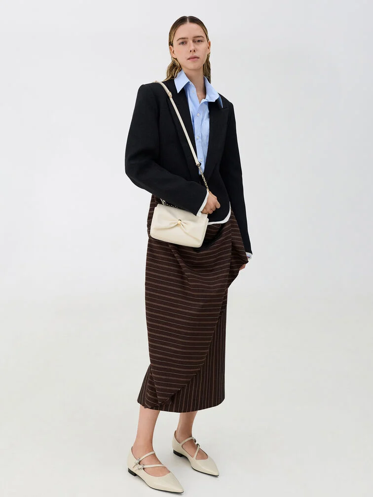 Mary Jane flats styled with a long skirt that allows the signature strap detail to remain visible.