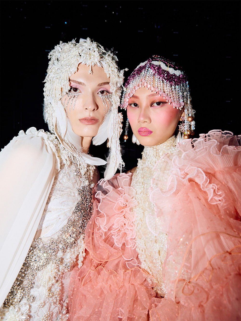 Two models pose backstage at the Romance Was Born show during Australia Fashion Week 2025 - CHARLES & KEITH