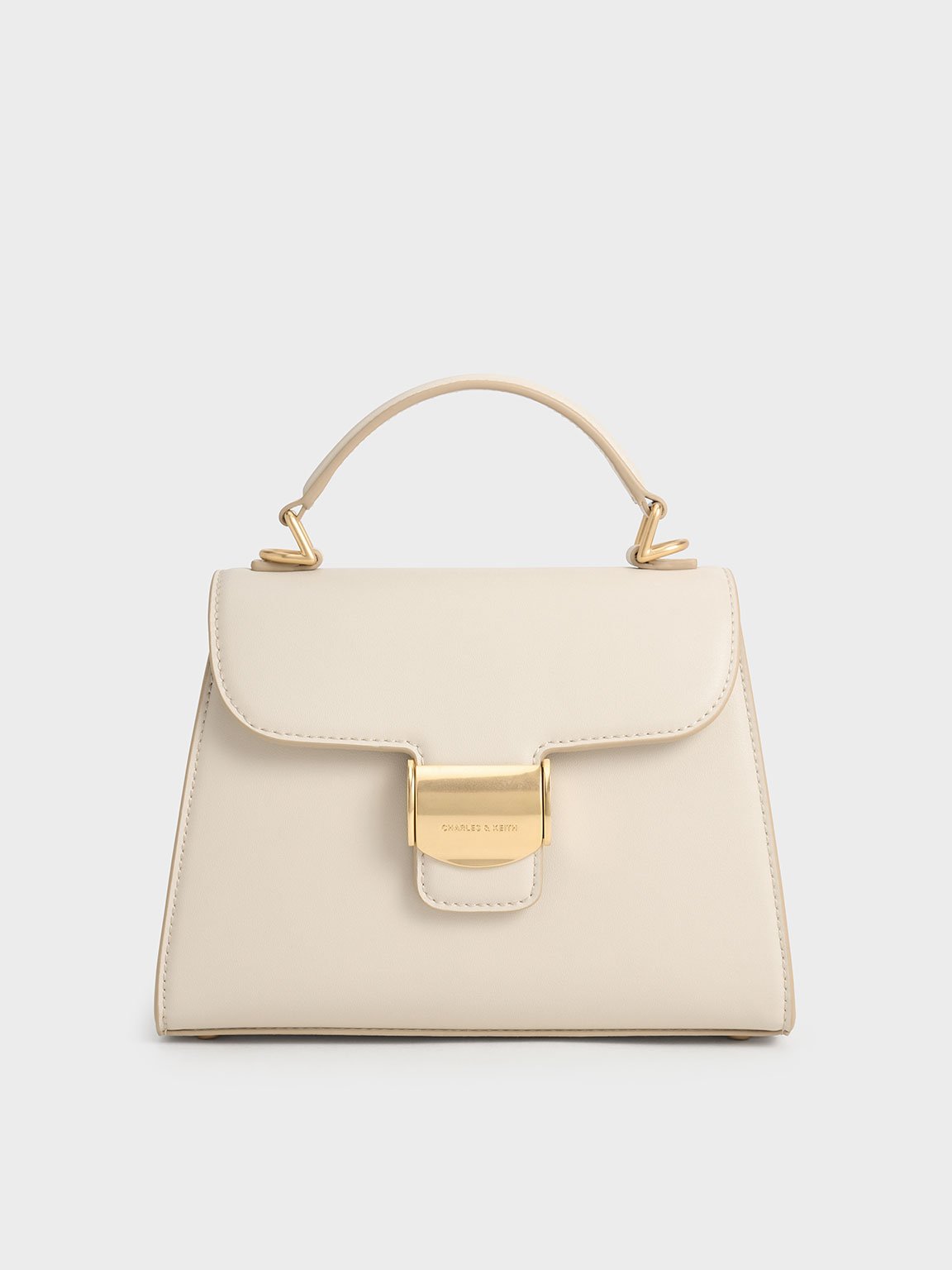Shop Charles & Keith Violetta Trapeze Top Handle Bag In Beige