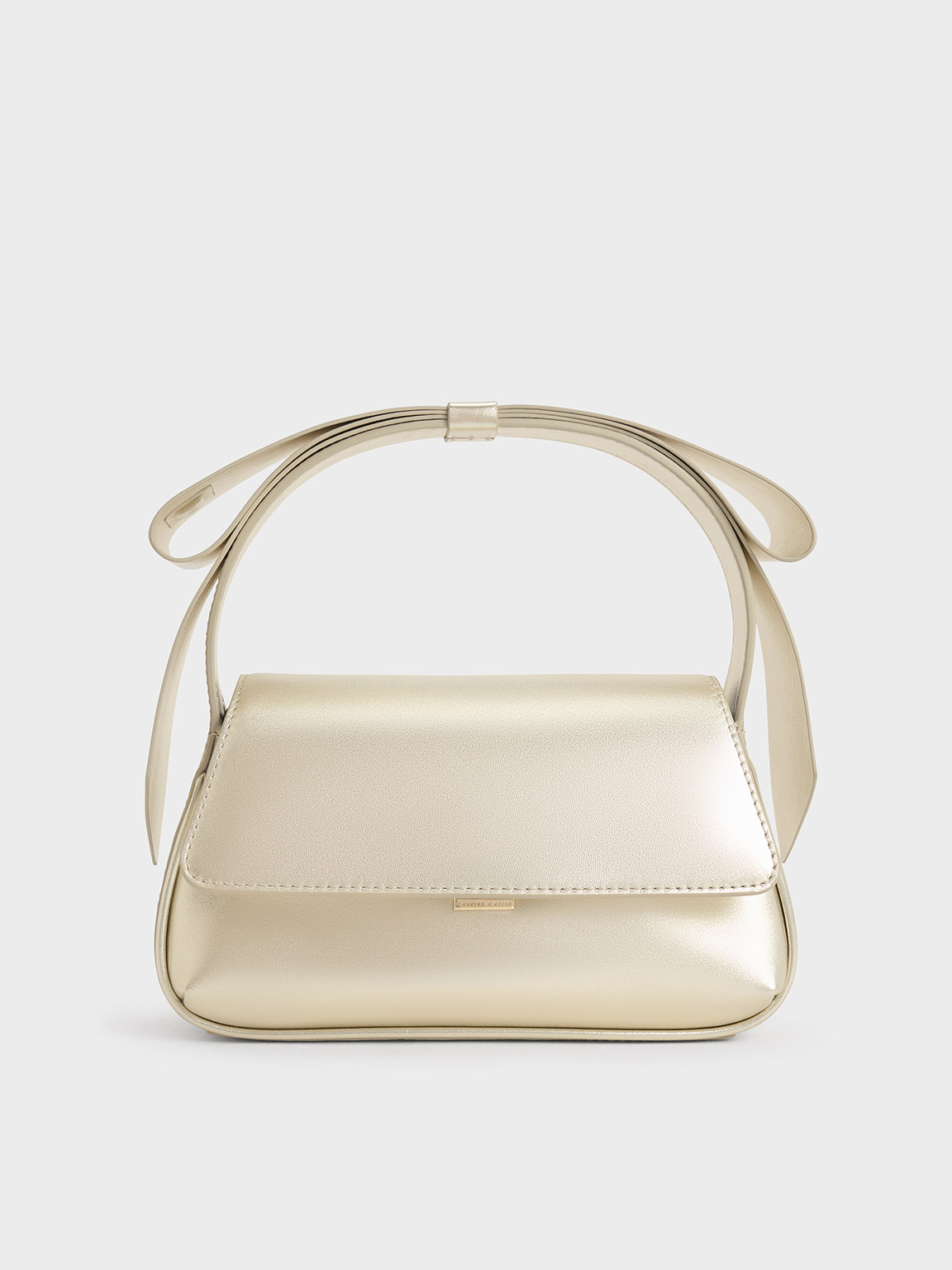 Shop Charles & Keith Leather Metallic Bow Top-handle Bag In Champagne